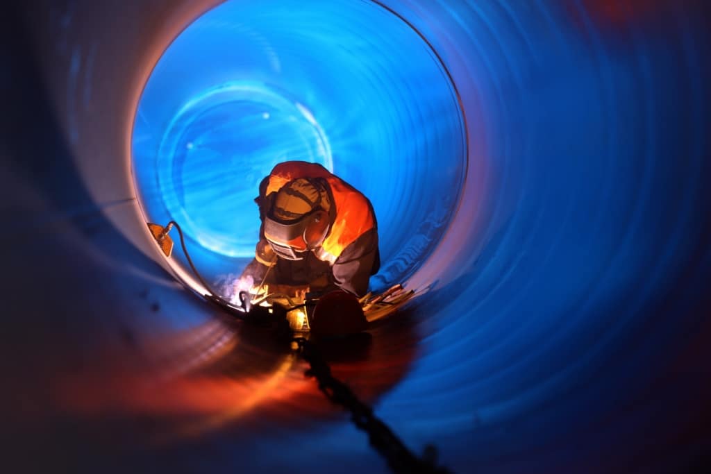 Soudeur dans un très grand cylindre qui soude la jointure de la structure